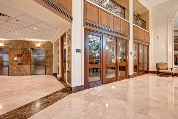 a kitchen with stainless steel appliances kitchen island granite countertop a stove a refrigerator and a dining table with wooden floor