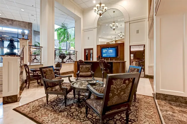 a living room with furniture a flat screen tv and a table