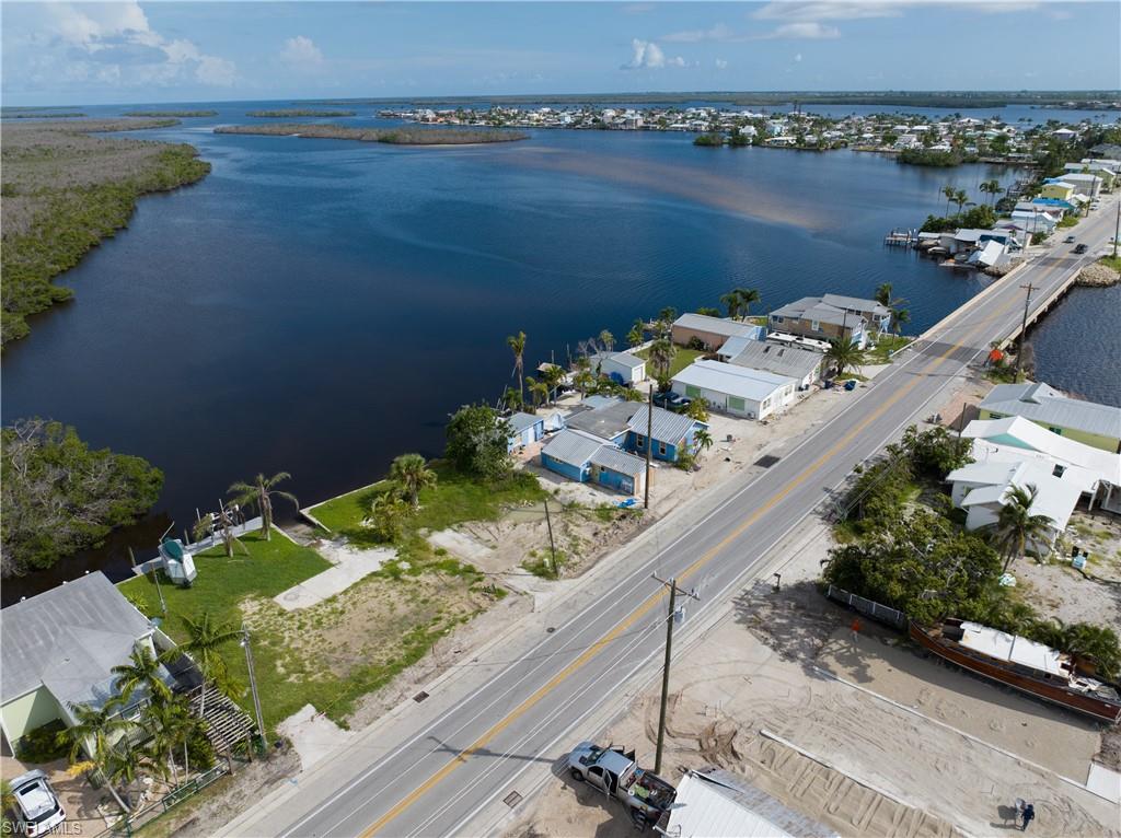 4850 Pine Island Road Bokeelia, FL 33922 - Photo 16 of 24 a view of a lake with a table and chairs