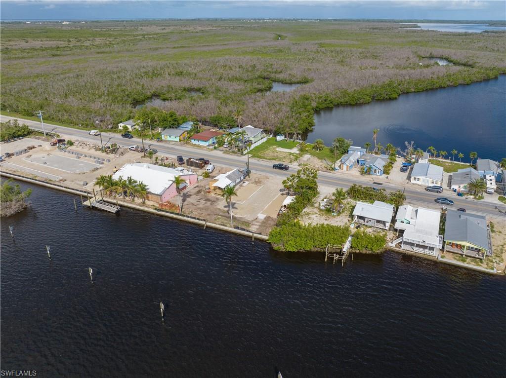 4850 Pine Island Road Bokeelia, FL 33922 - Photo 19 of 24 a view of a lake with a table and chairs