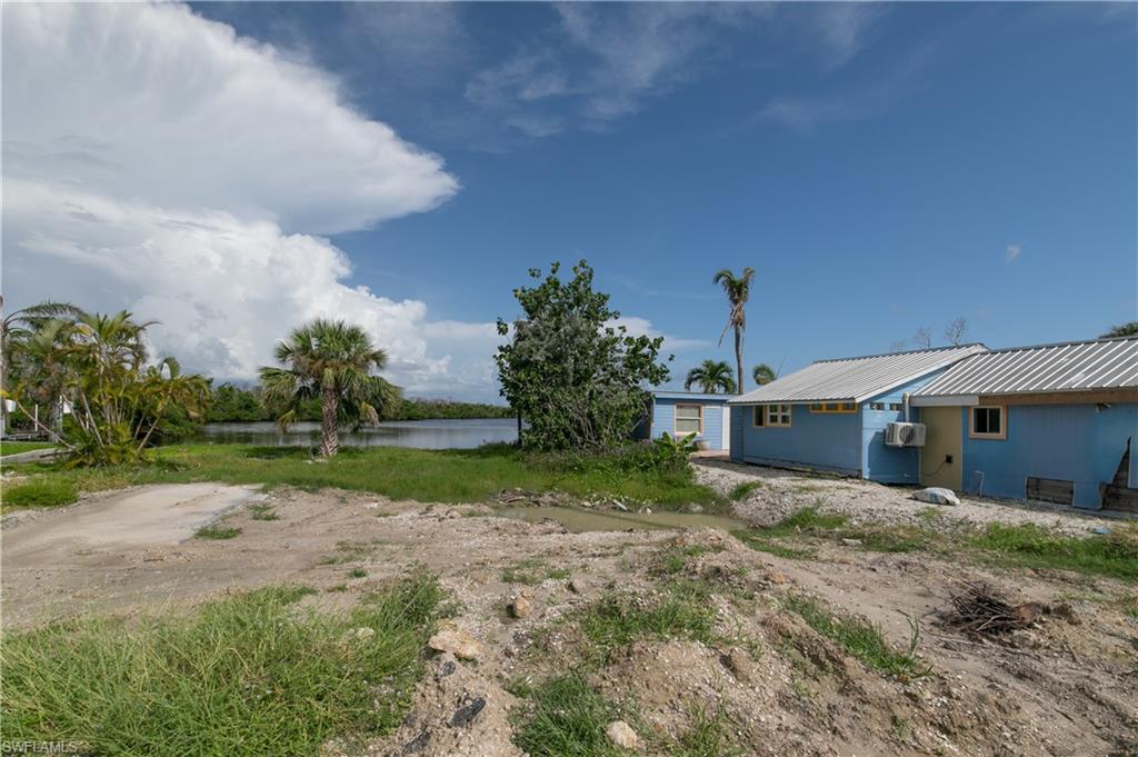 4850 Pine Island Road Bokeelia, FL 33922 - Photo 4 of 24 a view of a house with a yard