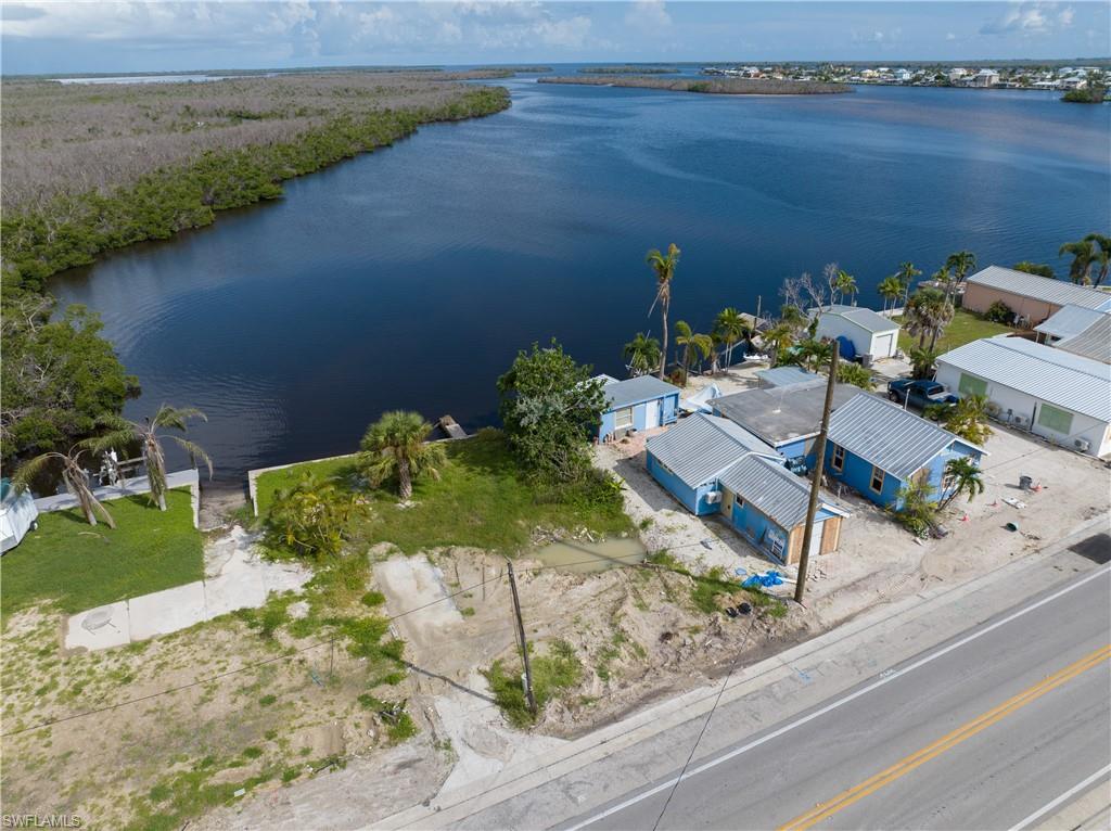 4850 Pine Island Road Bokeelia, FL 33922 - Photo 8 of 24 an aerial view of a house with a yard and lake view