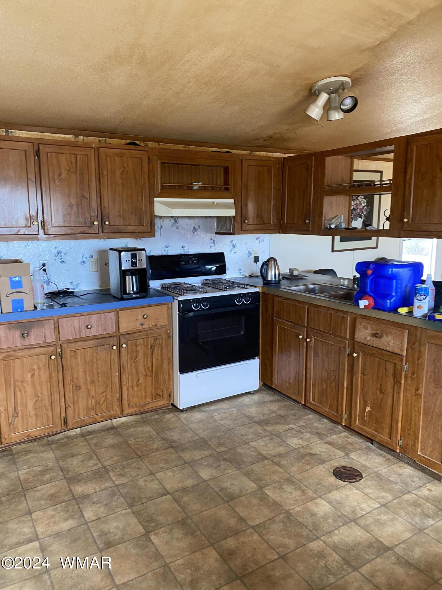 5149 Pj Ranch Road Snowflake, AZ 85937 - Photo 17 of 44 a kitchen with stainless steel appliances granite countertop a stove sink and cabinets