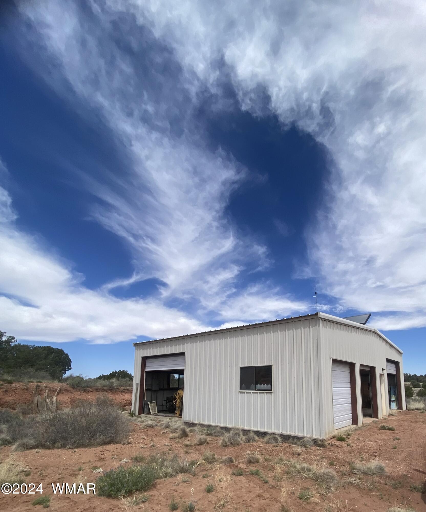 5149 Pj Ranch Road Snowflake, AZ 85937 - Photo 2 of 44 a backyard of a house with fireplace and wooden fence