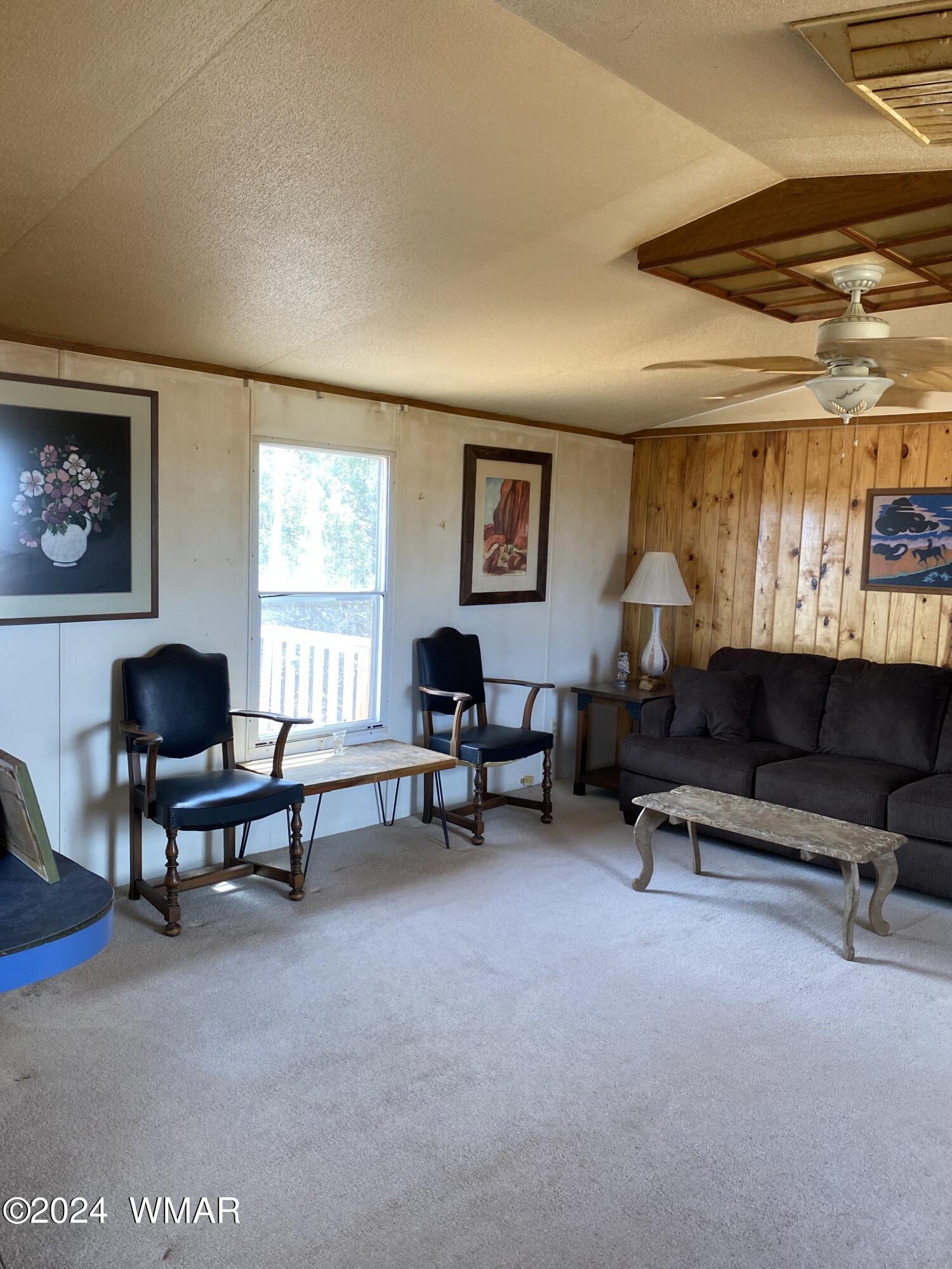 5149 Pj Ranch Road Snowflake, AZ 85937 - Photo 21 of 44 a living room with furniture a piano and a window