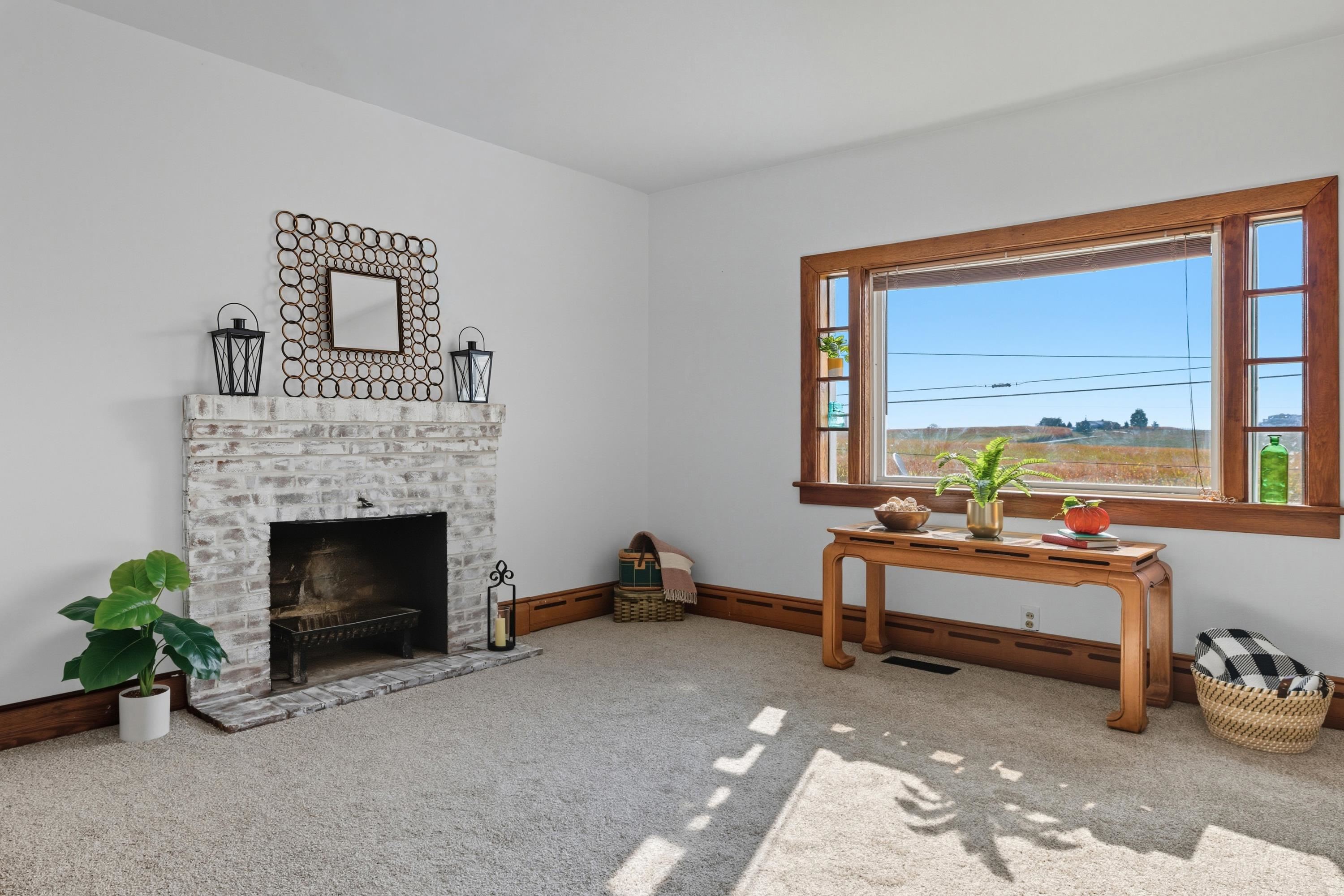 3138 Cross Keys Road Harrisonburg, VA 22801 - Photo 23 of 74 The living room space is located off the entrance to the home and near the steps leading to the upper level. This space features a fireplace, comfortable flooring, updated light fixture, and large windows allowing in an abundance of natural light!