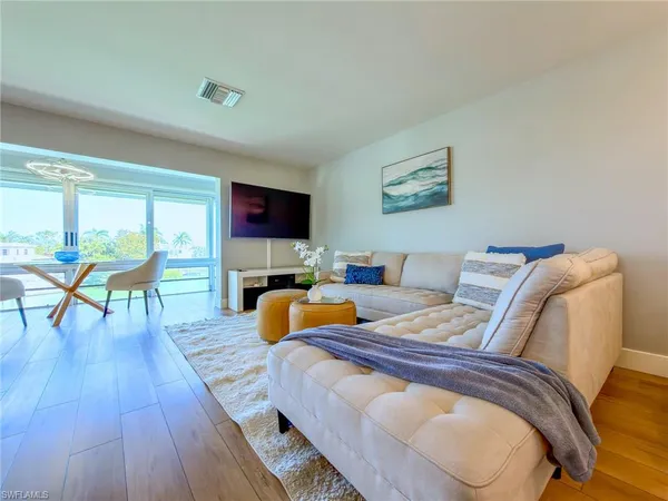 a bedroom with furniture and a wooden floor