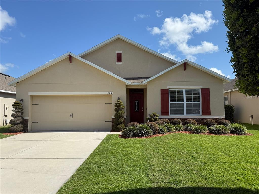 306 Briar Patch Loop Davenport, FL 33896 - Photo 1 of 1 a front view of a house with garden