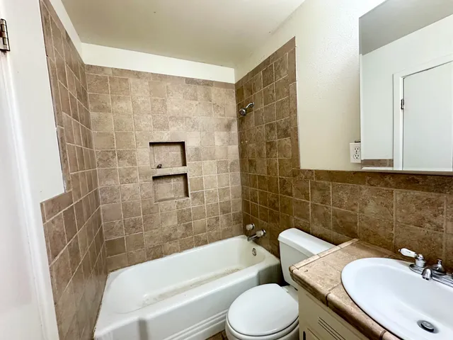 a bathroom with a sink a toilet and bathtub