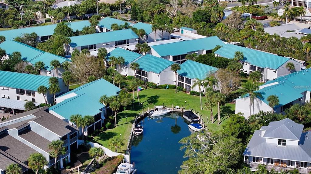 an aerial view of multiple houses with yard