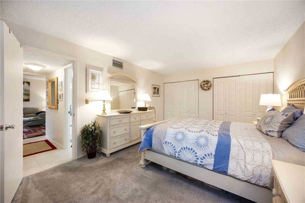 5631 Midnight Pass Road, Unit 1002 Sarasota, FL 34242 - Photo 17 of 30 a bedroom with a bed and a view of bedroom