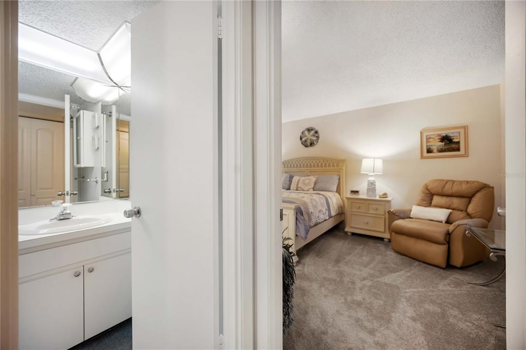 5631 Midnight Pass Road, Unit 1002 Sarasota, FL 34242 - Photo 19 of 30 a en suite bathroom with a double vanity sink a mirror and a bathtub