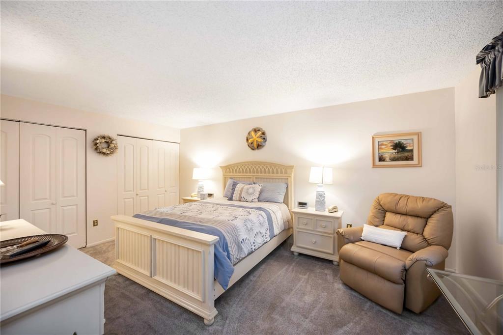 5631 Midnight Pass Road, Unit 1002 Sarasota, FL 34242 - Photo 20 of 30 a bedroom with a bed and a couch