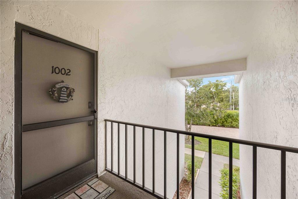 5631 Midnight Pass Road, Unit 1002 Sarasota, FL 34242 - Photo 2 of 30 a view of a hallway with wooden floor and a bathroom