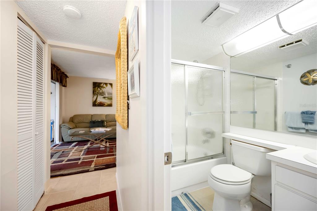 5631 Midnight Pass Road, Unit 1002 Sarasota, FL 34242 - Photo 21 of 30 a bathroom with a toilet sink and shower
