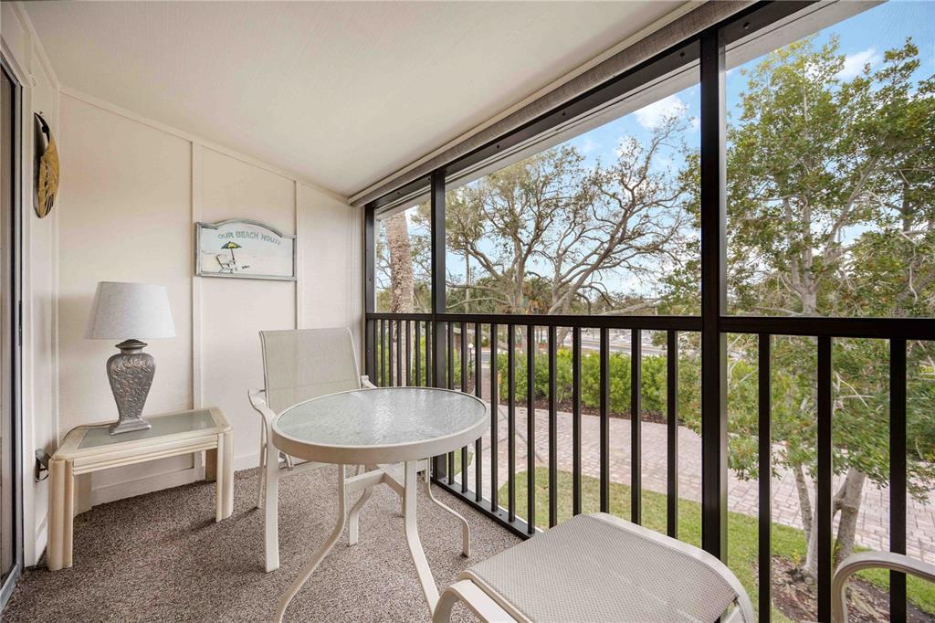 5631 Midnight Pass Road, Unit 1002 Sarasota, FL 34242 - Photo 27 of 30 a living room with furniture and a window