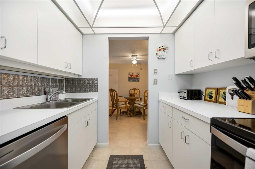 5631 Midnight Pass Road, Unit 1002 Sarasota, FL 34242 - Photo 9 of 30 a kitchen with a sink cabinets and appliances