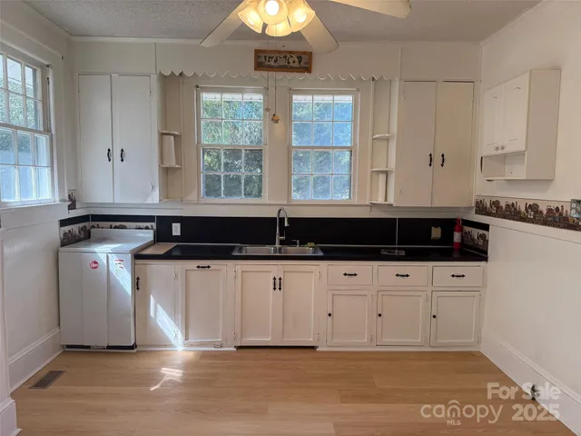 a kitchen with a sink and cabinets