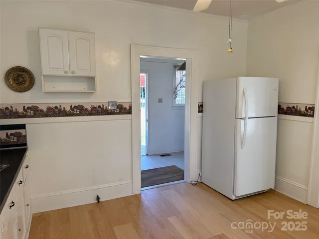 a kitchen with a refrigerator and a stove