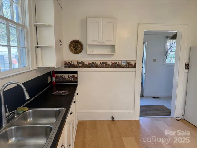 a kitchen with a sink and a refrigerator