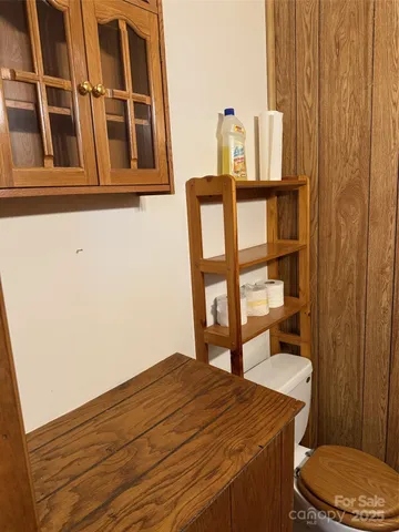 a bathroom with a granite countertop shower and a toilet