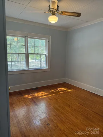 a view of room with wooden floor
