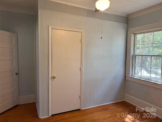 a view of a room with wooden floor