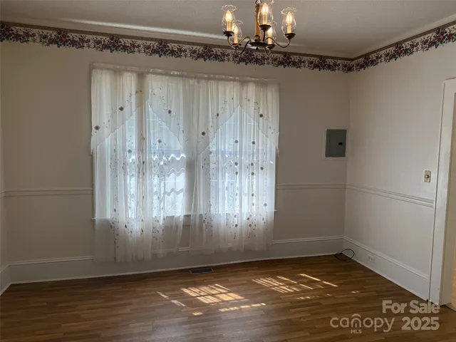 a view of a hallway with wooden floor and closet