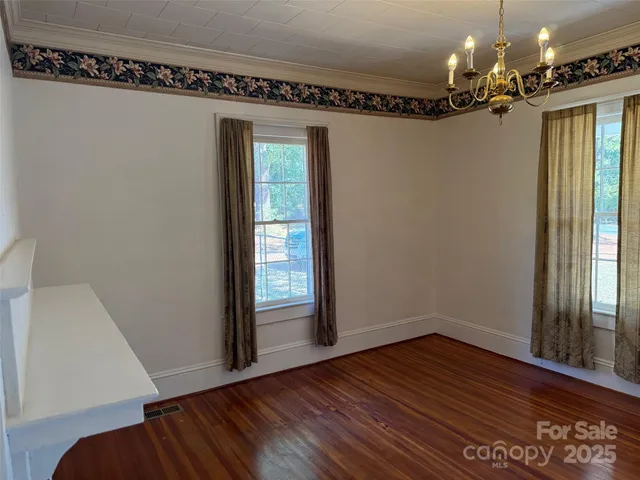 a view of a room with wooden floor