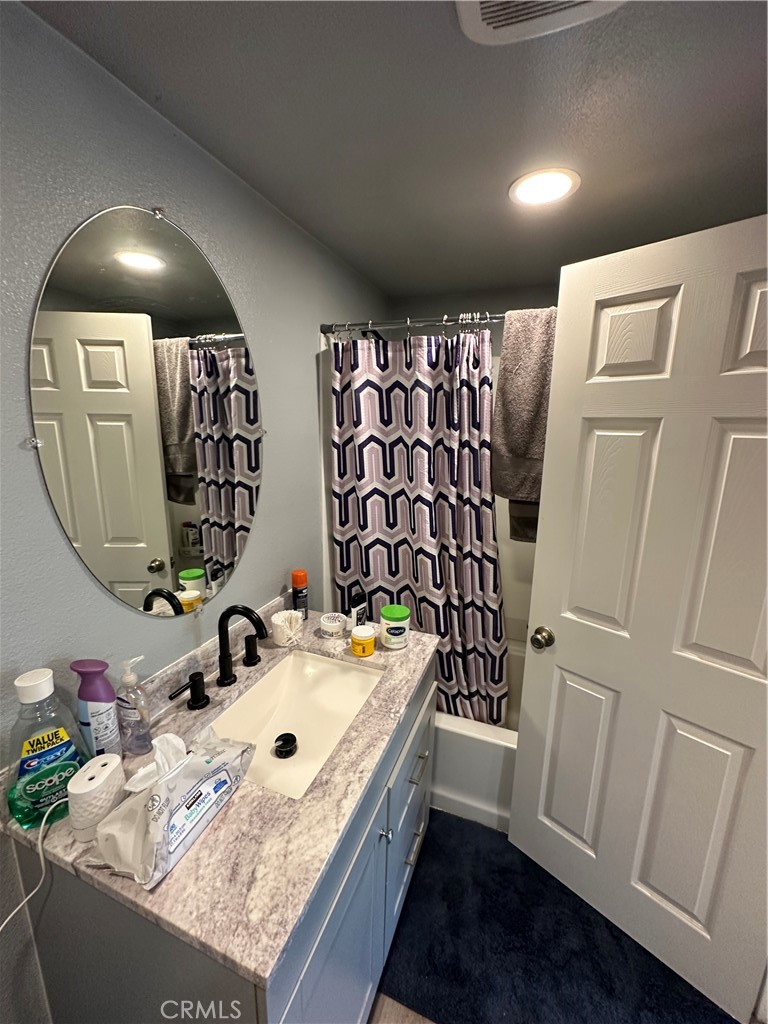 26326 Investors Hemet, CA 92544 - Photo 13 of 16 a bathroom with a sink vanity and a mirror