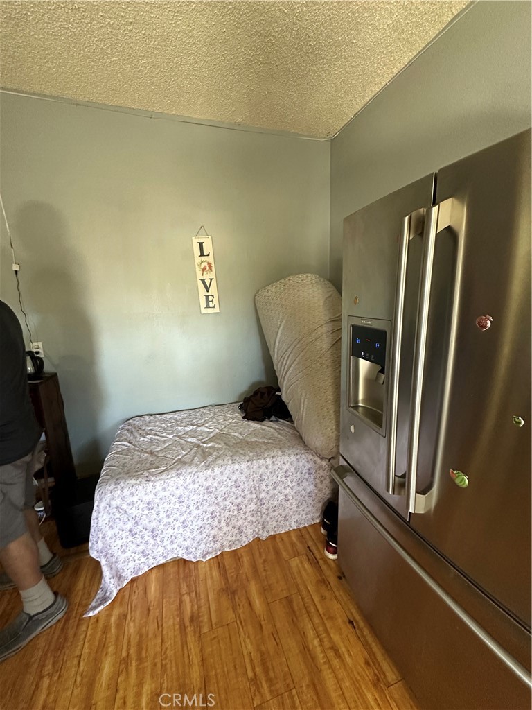 26326 Investors Hemet, CA 92544 - Photo 15 of 16 a bedroom with a bed and wooden floor