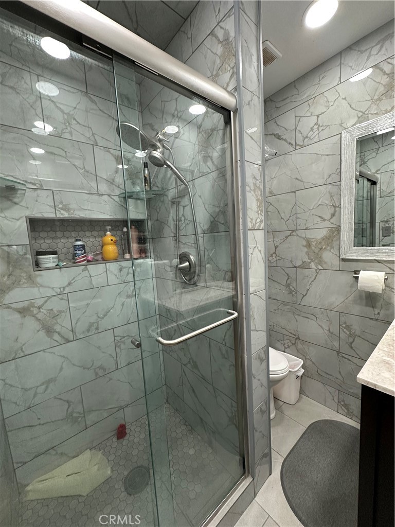 26326 Investors Hemet, CA 92544 - Photo 3 of 16 a bathroom with a shower and toilet