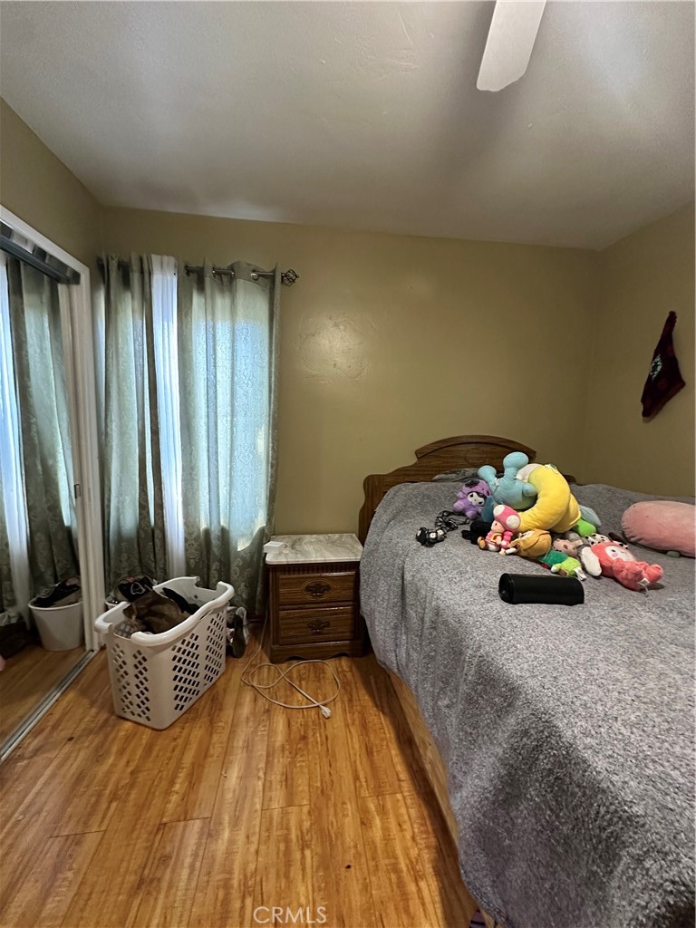 26326 Investors Hemet, CA 92544 - Photo 4 of 16 a bedroom with a bed and a potted plant