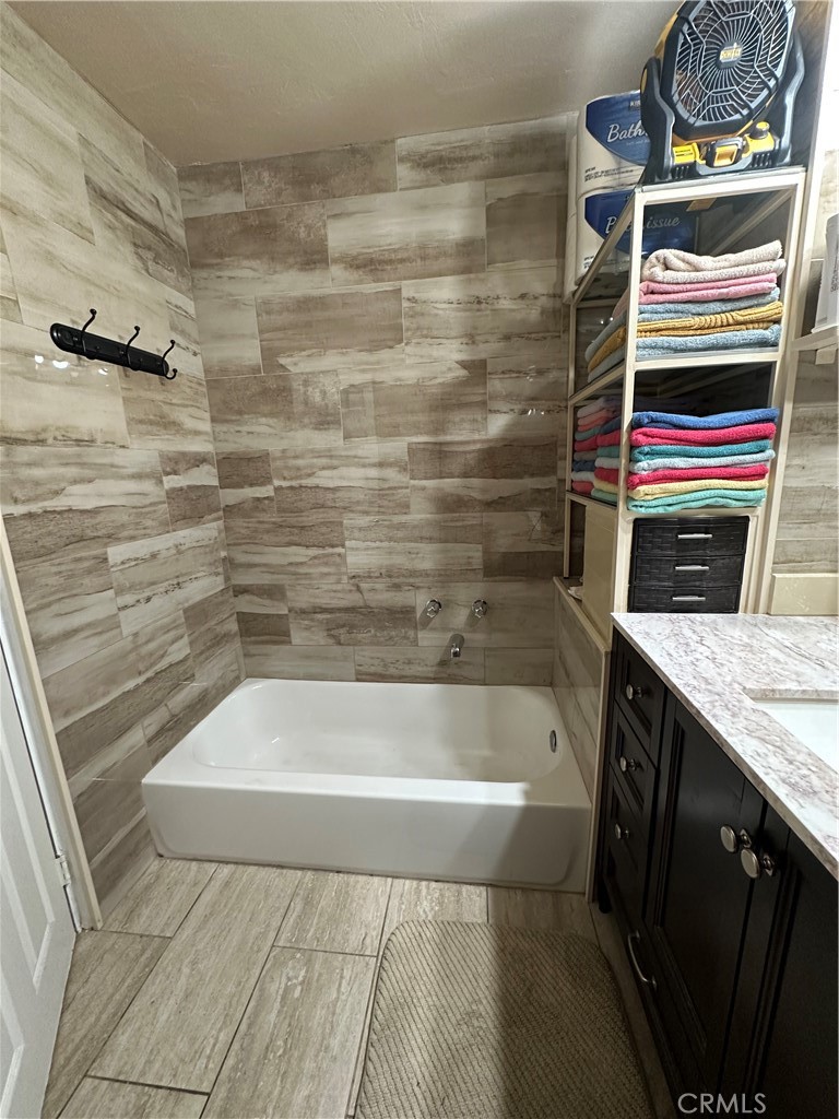 26326 Investors Hemet, CA 92544 - Photo 6 of 16 a bathroom with a bathtub and a shower