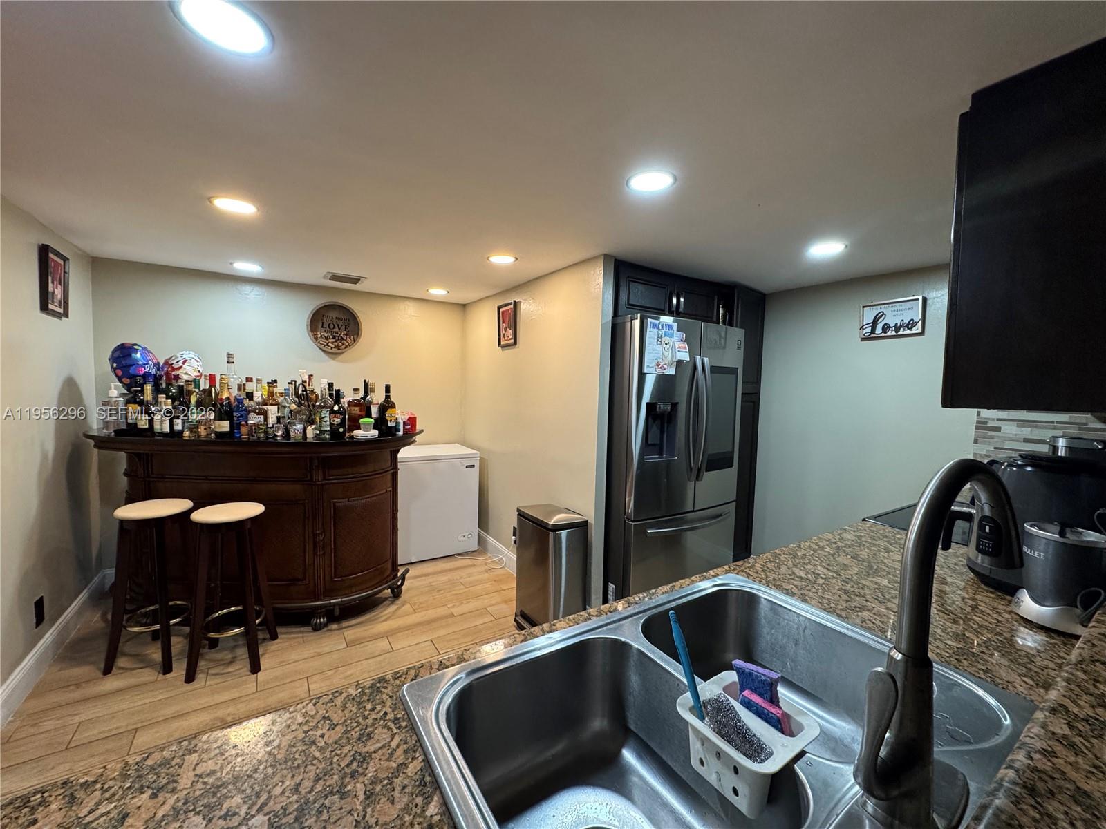 9412 Northwest 39th Street Sunrise, FL 33351 - Photo 14 of 23 a kitchen with a refrigerator and a sink