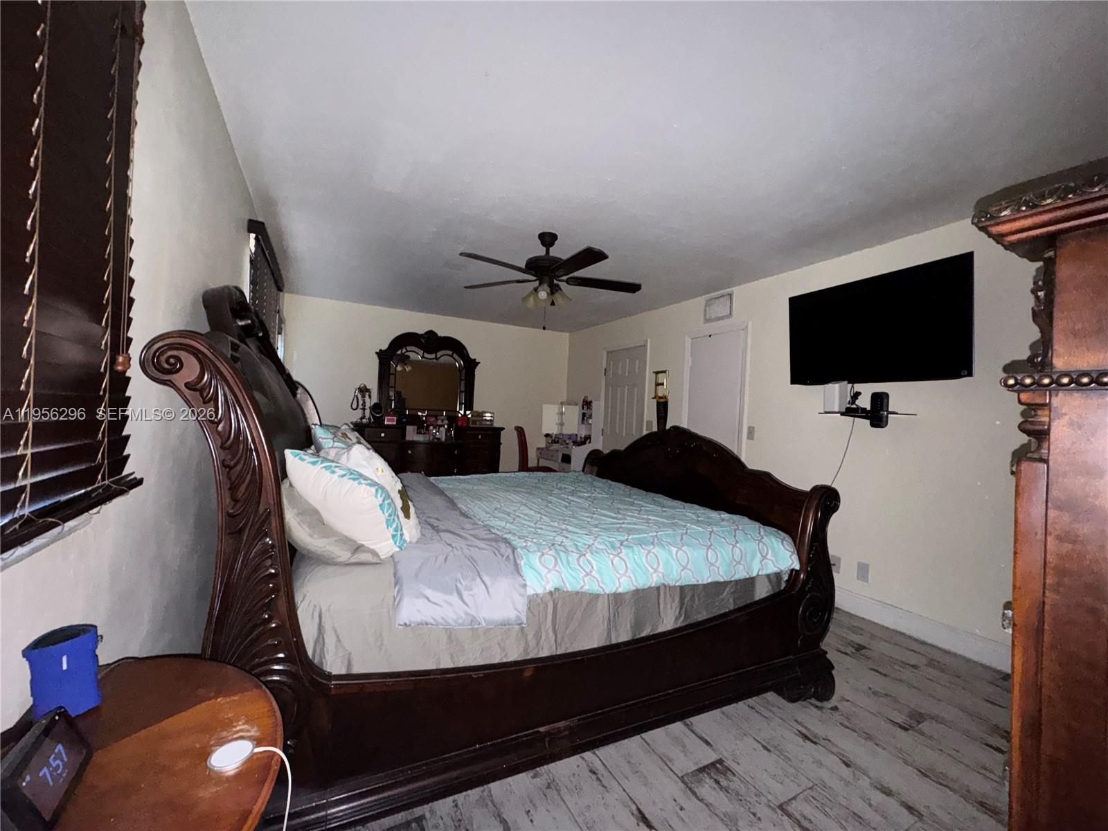 9412 Northwest 39th Street Sunrise, FL 33351 - Photo 15 of 23 a bed room with a bed tv and a chair