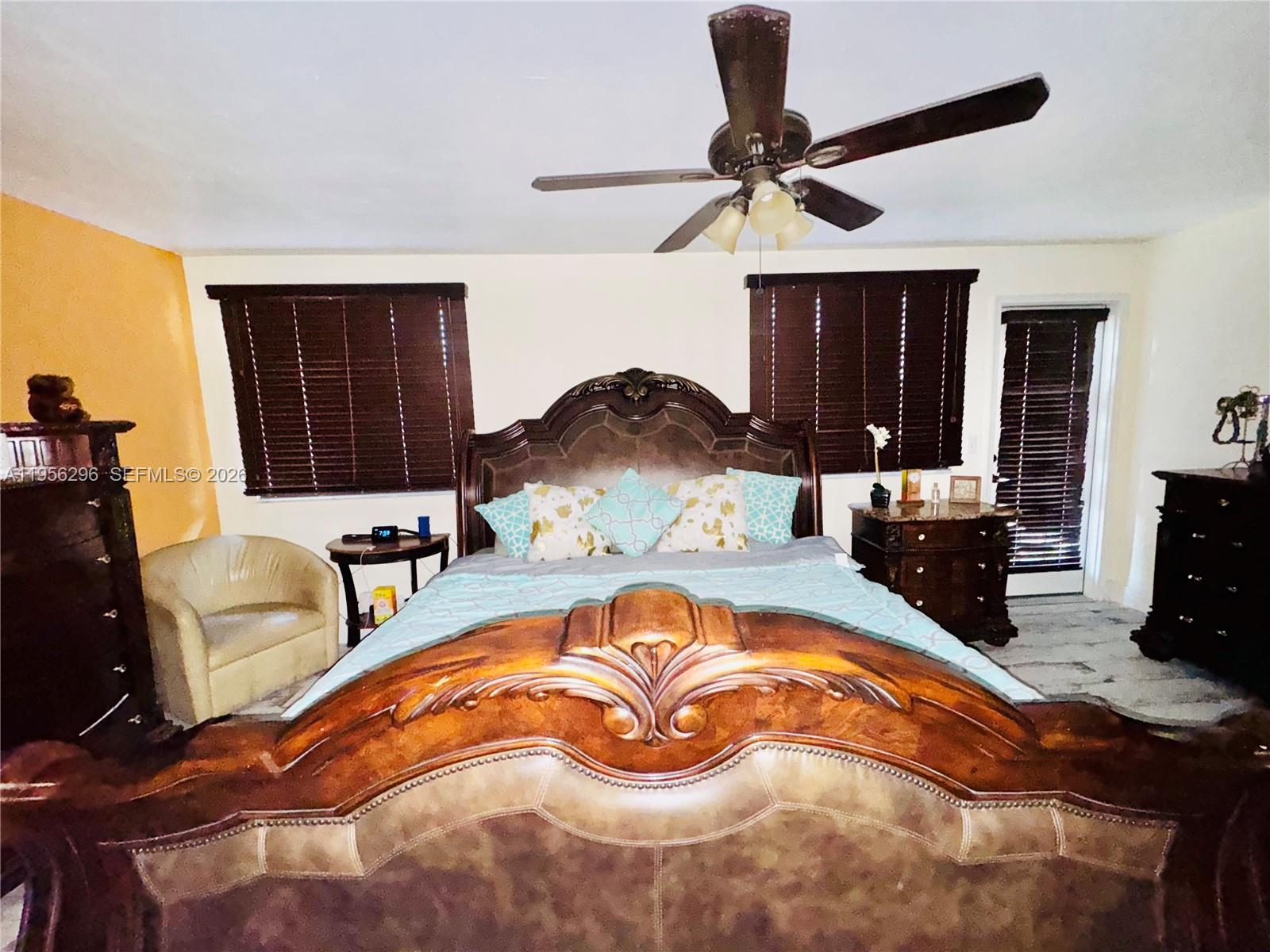 9412 Northwest 39th Street Sunrise, FL 33351 - Photo 19 of 23 a bed room with a bed and a chandelier
