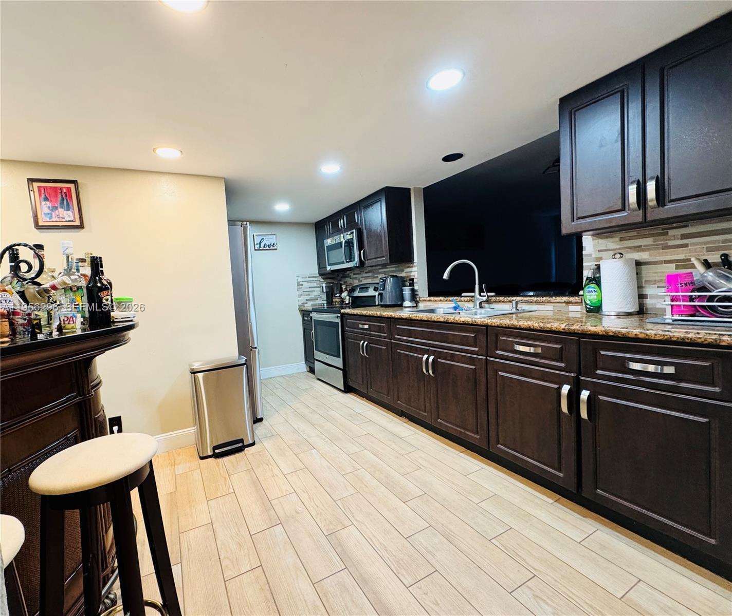 9412 Northwest 39th Street Sunrise, FL 33351 - Photo 21 of 23 a kitchen with stainless steel appliances granite countertop a sink and a stove