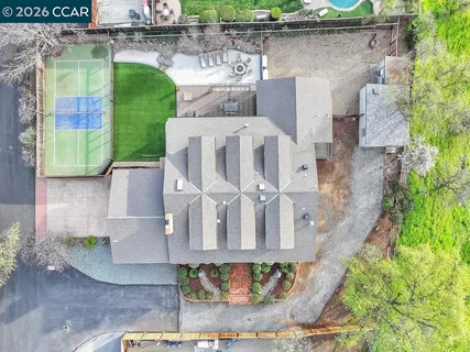 an aerial view of a house with a yard