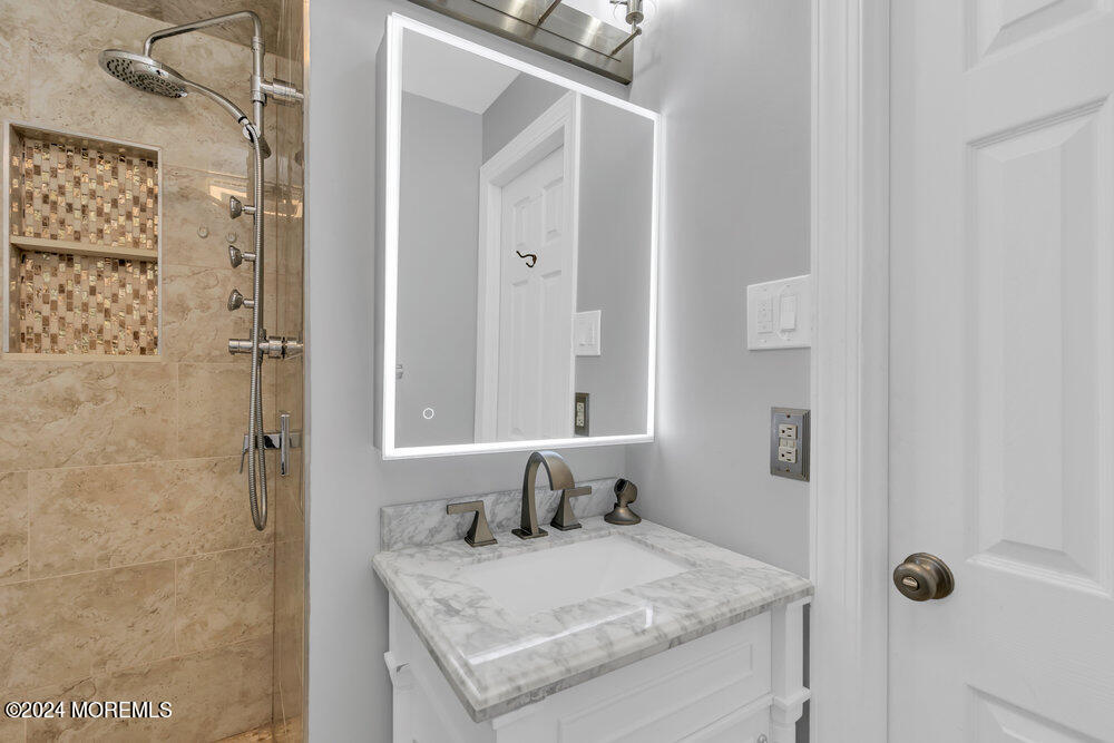6 Firethorne Road Cherry Hill, NJ 08003 - Photo 25 of 52 a bathroom with a granite countertop sink and a mirror