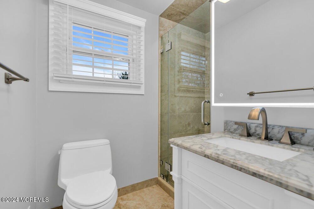 6 Firethorne Road Cherry Hill, NJ 08003 - Photo 26 of 52 a bathroom with a granite countertop toilet a sink and a mirror