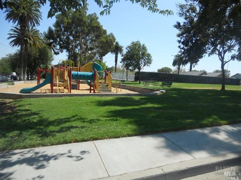 420 Montezuma Street, Unit C Rio Vista, CA 94571 - Photo 6 of 7 a backyard of a house with table and chairs plants and trees