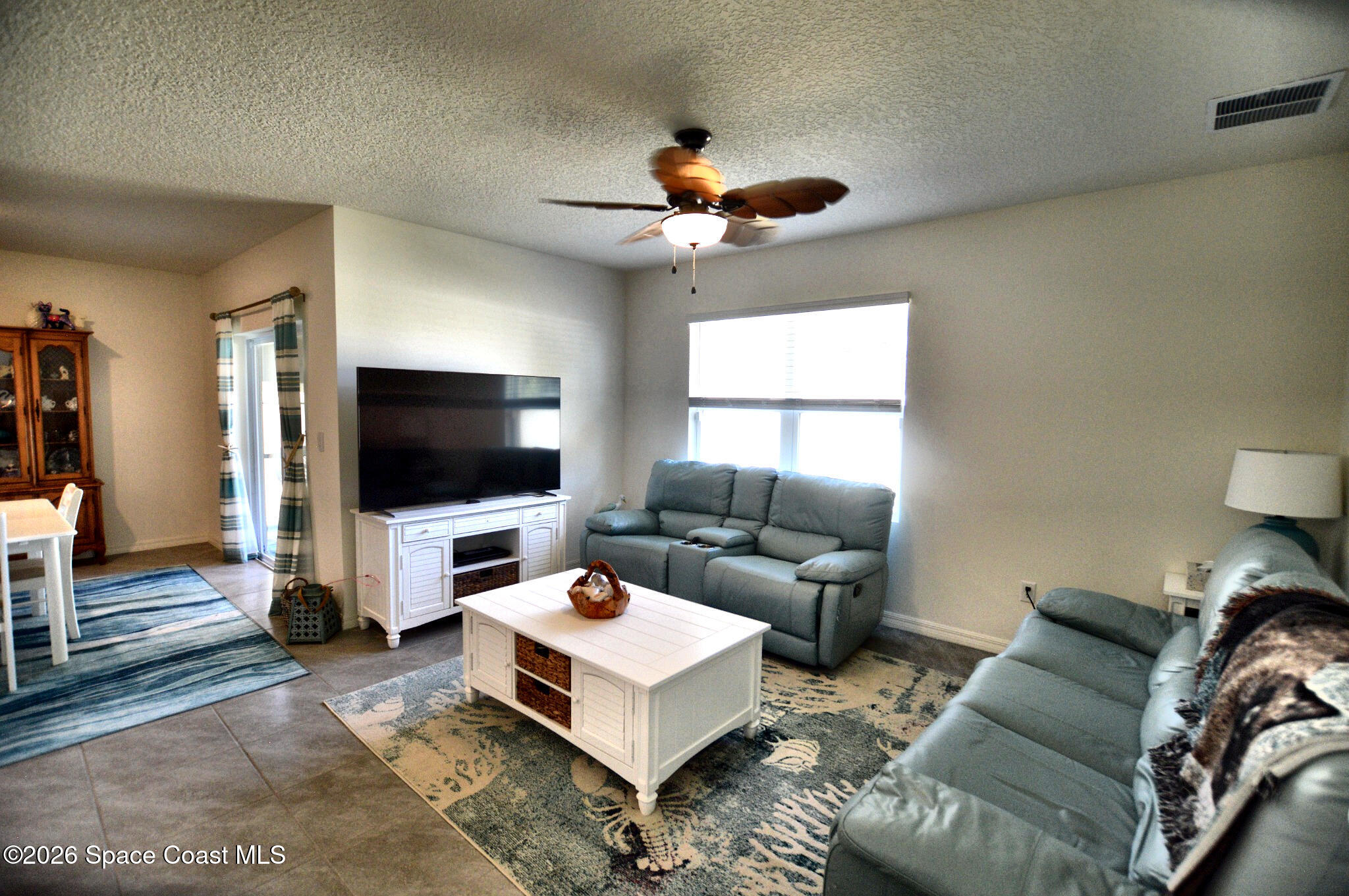 977 Trinity Street Rockledge, FL 32955 - Photo 12 of 18 a living room with furniture and a flat screen tv
