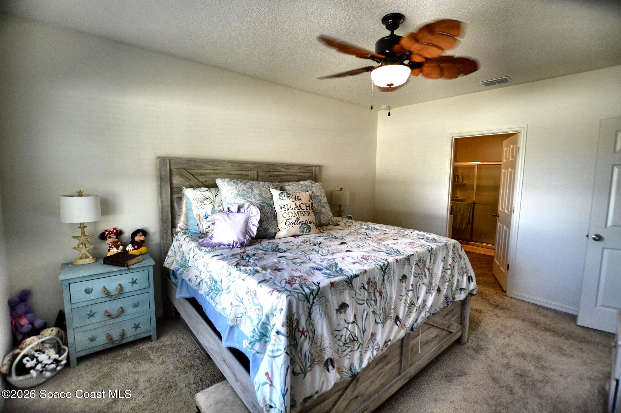 977 Trinity Street Rockledge, FL 32955 - Photo 15 of 18 a bedroom with a bed and a chandelier