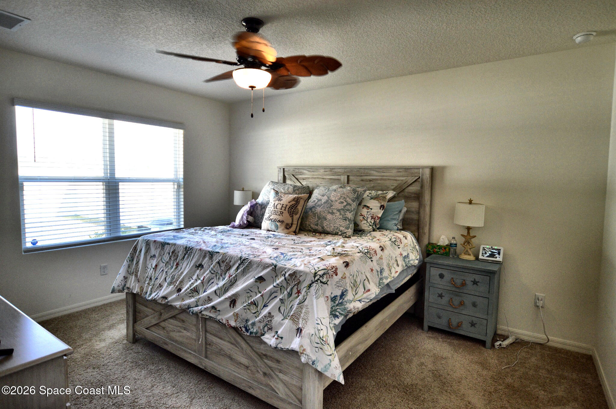 977 Trinity Street Rockledge, FL 32955 - Photo 16 of 18 a bedroom with a bed and a chandelier