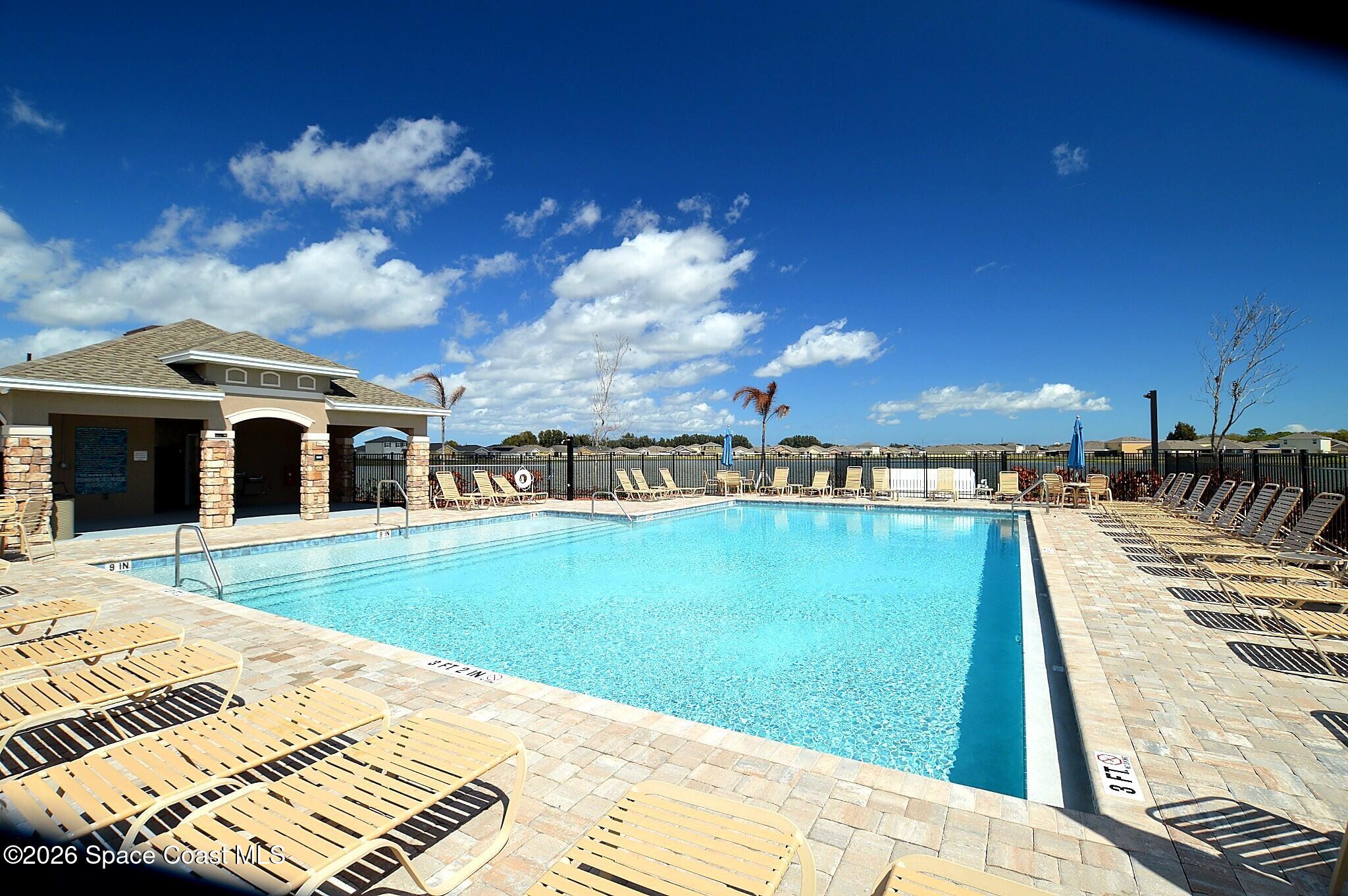 977 Trinity Street Rockledge, FL 32955 - Photo 17 of 18 a view of a swimming pool with an outdoor seating
