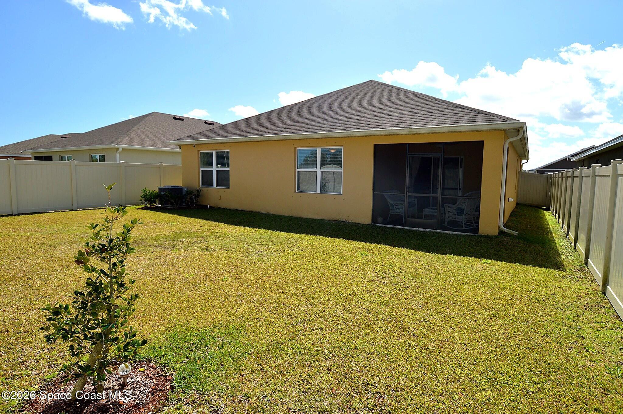 977 Trinity Street Rockledge, FL 32955 - Photo 3 of 18 a front view of a house with a yard