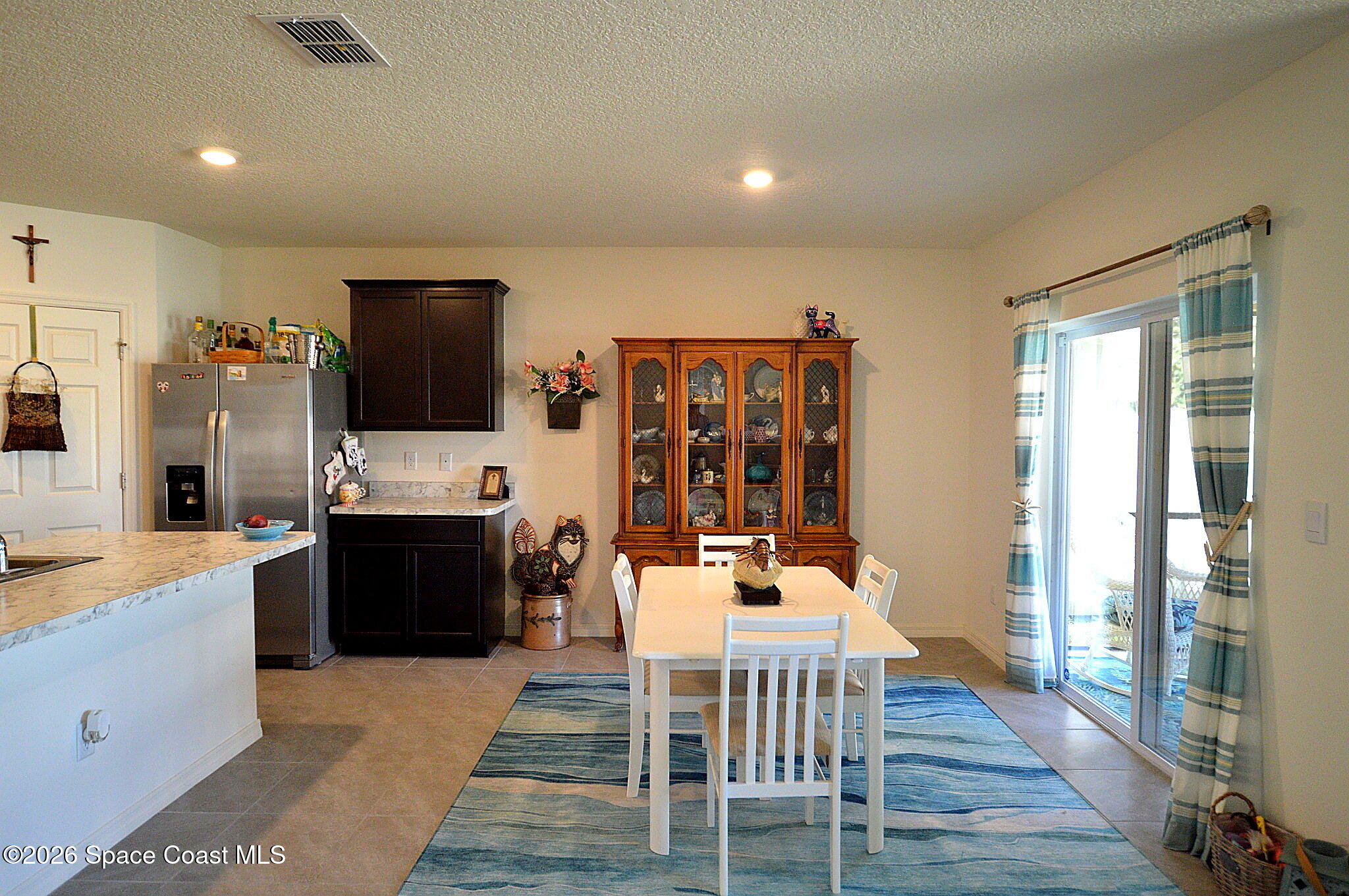977 Trinity Street Rockledge, FL 32955 - Photo 10 of 18 a view of a dining room with furniture a fireplace and wooden floor