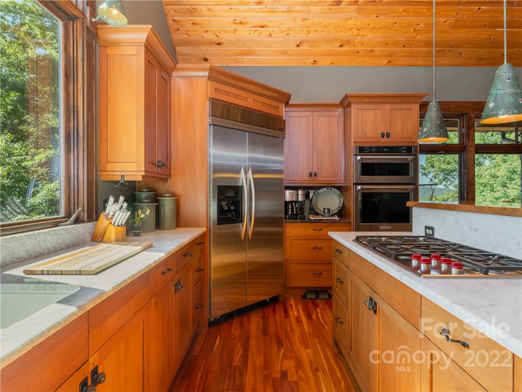 168 Pinkerton Corner Fairview, NC 28730 - Photo 16 of 48 a kitchen with a stove a sink and a refrigerator