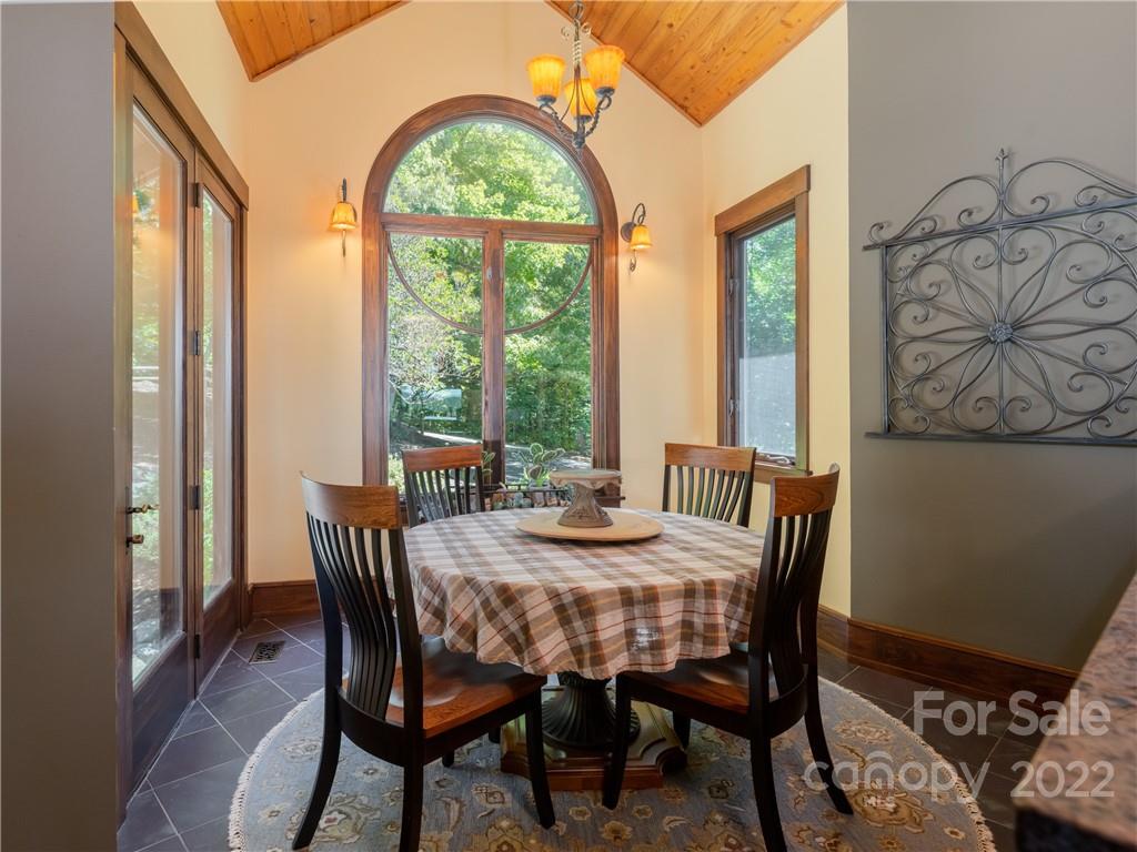 168 Pinkerton Corner Fairview, NC 28730 - Photo 18 of 48 a view of a dining room with furniture a chandelier and wooden floor